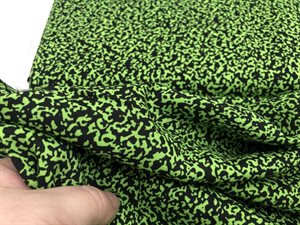 Fastvævet viscose - frisk grønt mønster på sort bund